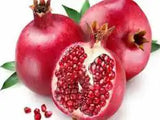 Fresh ZabhiaNow pomegranate with vibrant red seeds and green leafy top, showcasing its juicy, ripe interior.