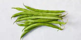 Fresh green beans from ZabhiaNow displayed in a basket, showcasing their vibrant color and crisp texture.