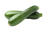 Fresh green zucchini from ZabhiaNow, displayed on a white background, showcasing its smooth skin and vibrant color.